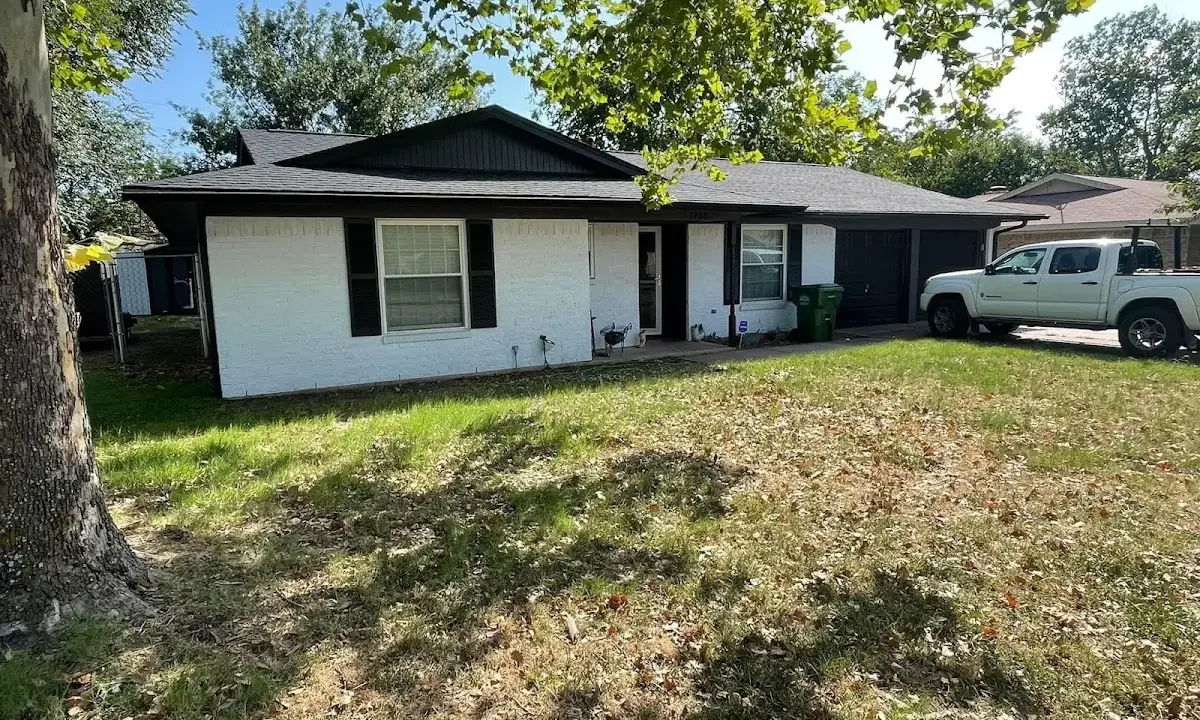 Professional roofing crew working on a residential roof in Johnston
